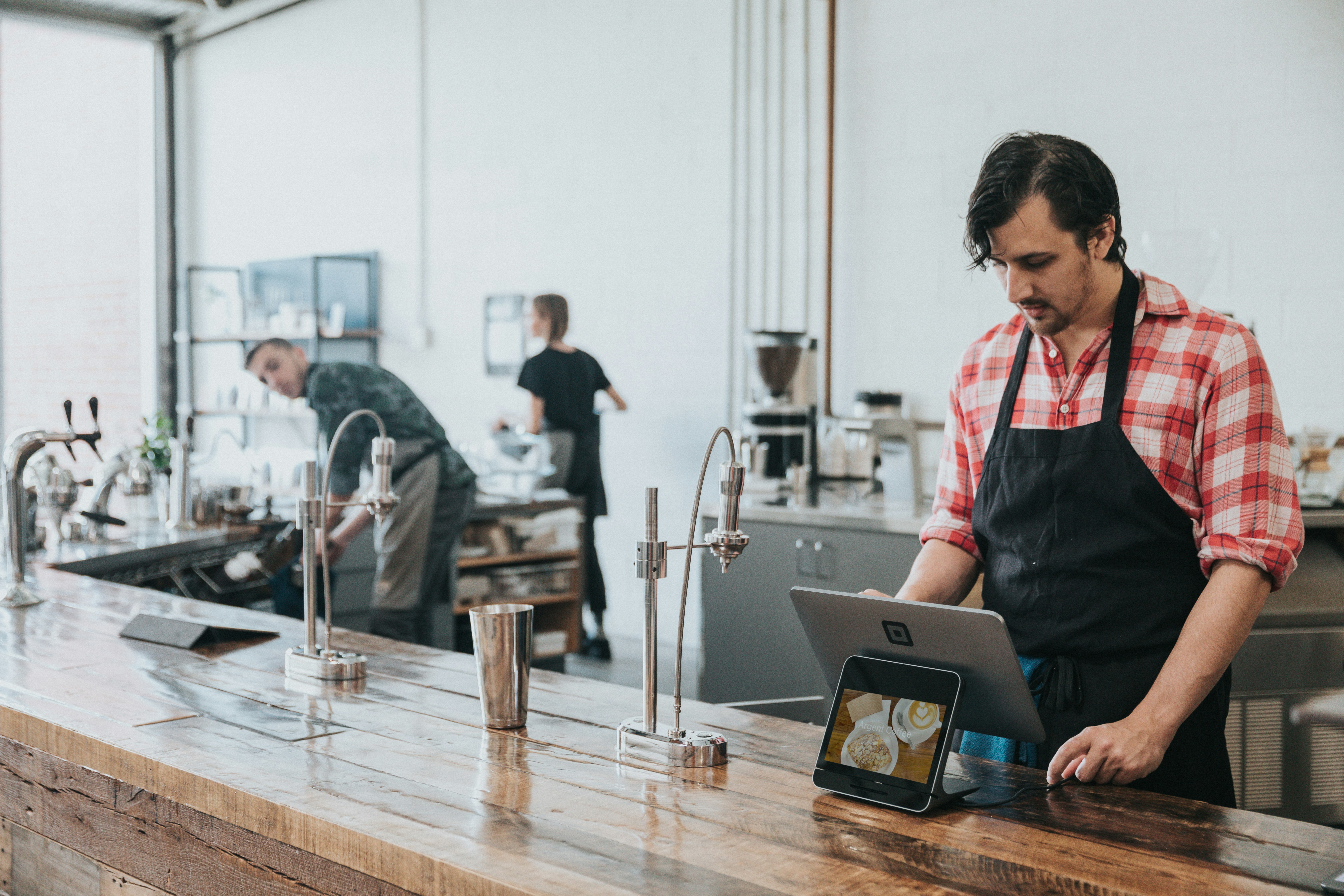 Man at counter with iPad